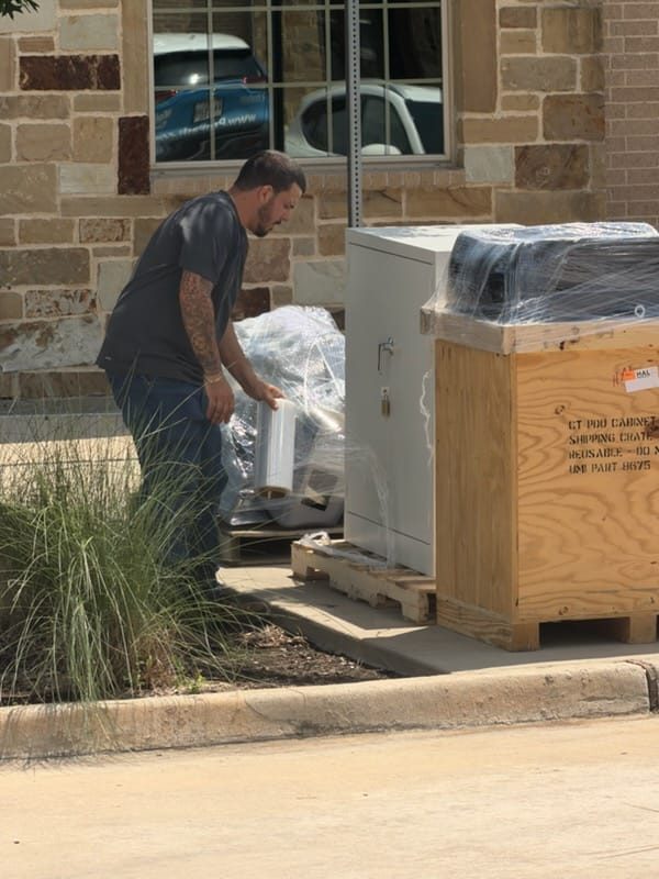 Badass Logistics crew shrink-wrapping and crating electrical equipment for shipment