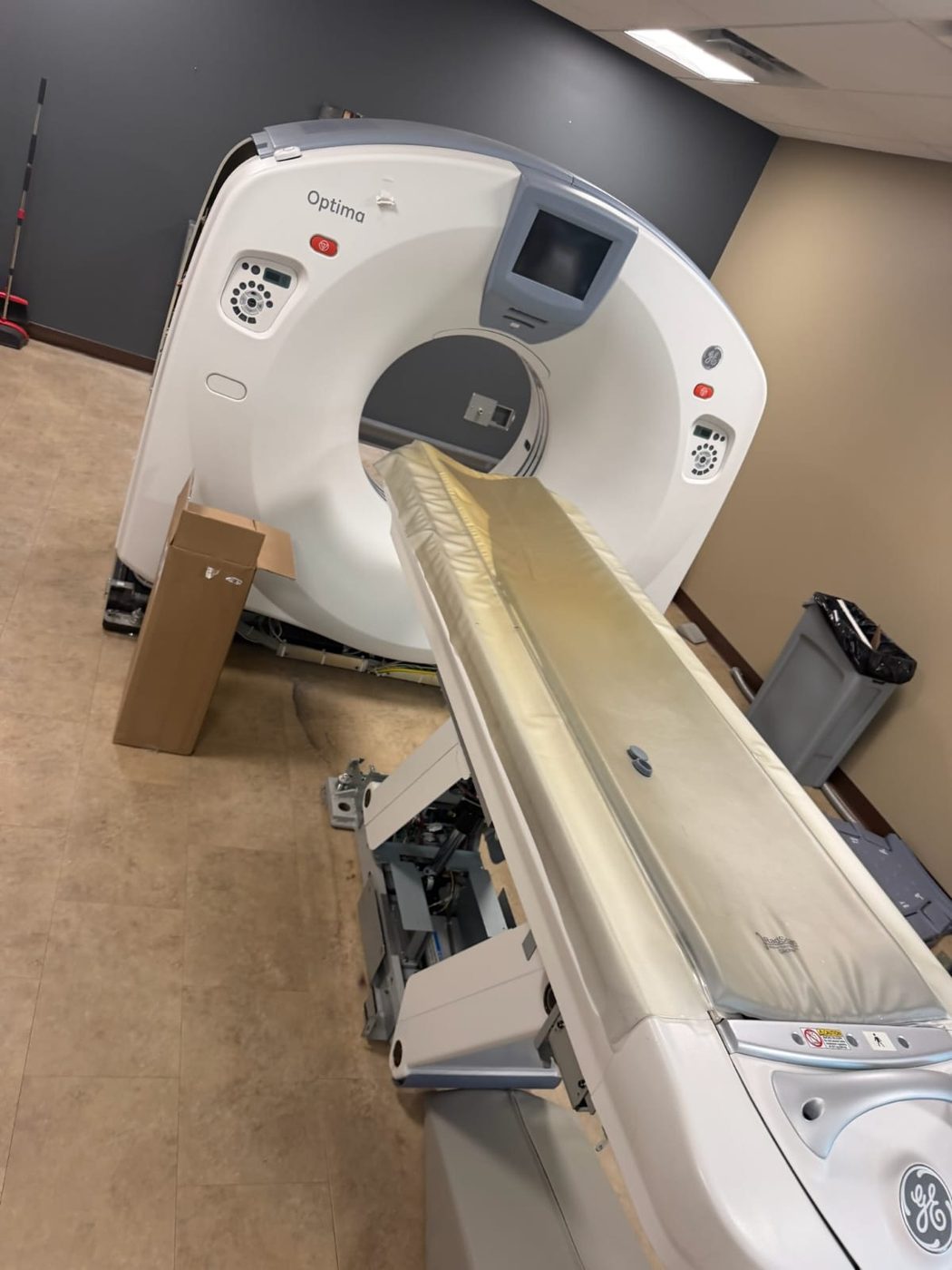 GE Optima CT scanner being prepped for relocation inside a medical imaging suite by Badass Logistics