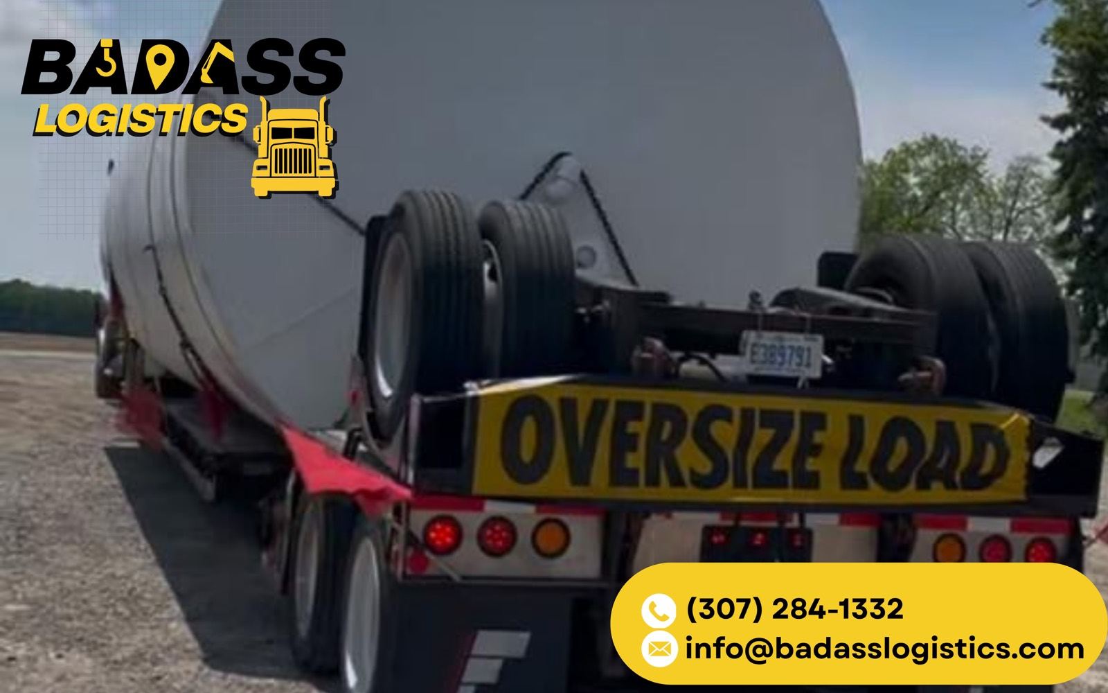 Oversize load โ large tank hauled on a red lowboy trailer by Badass Logistics