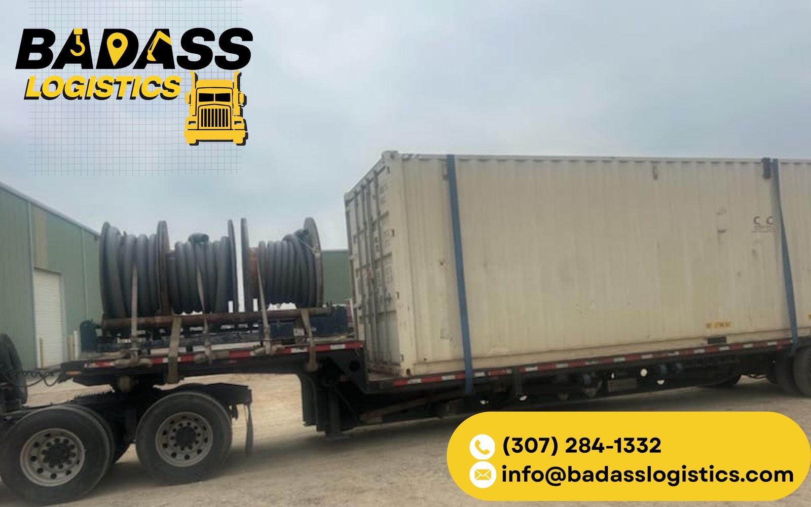Flatbed hauling industrial cable reels and a shipping container